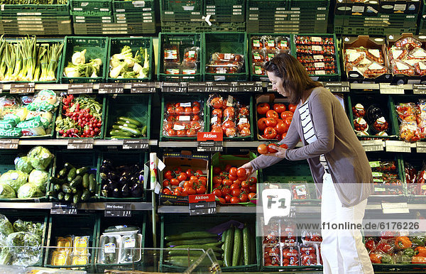 Frau kauft in der Gemüseabteilung ein  Selbstbedienung  Deutschland  Europa