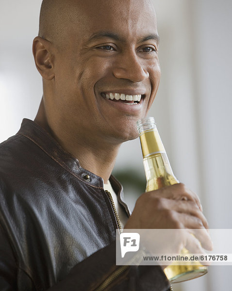 African man drinking beer