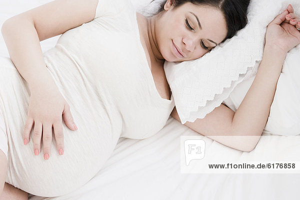 Pregnant Hispanic woman sleeping