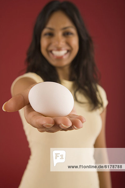 Indian woman holding egg