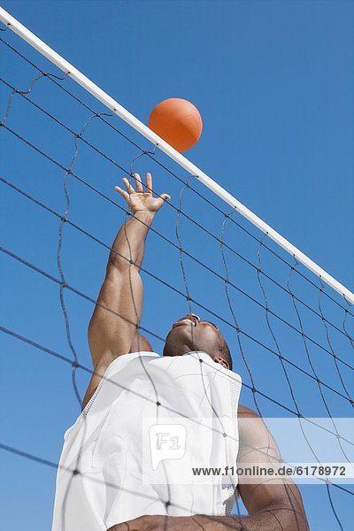 African man playing volleyball