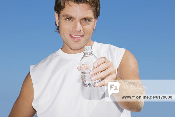 Hispanic man holding water bottle