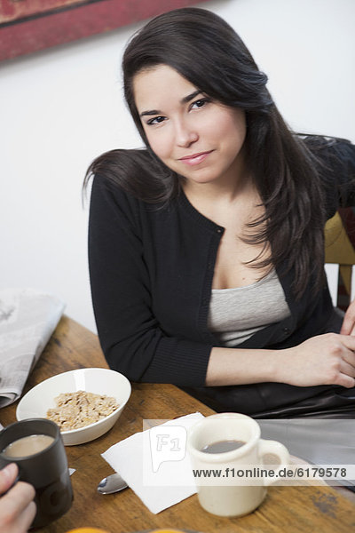 Hispanic woman eating breakfast