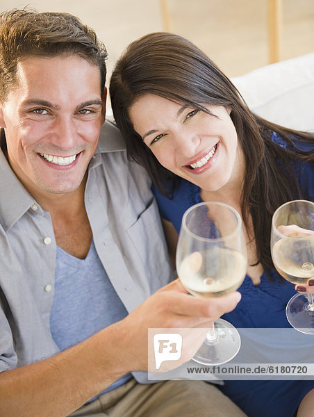 Couple drinking white wine and toasting