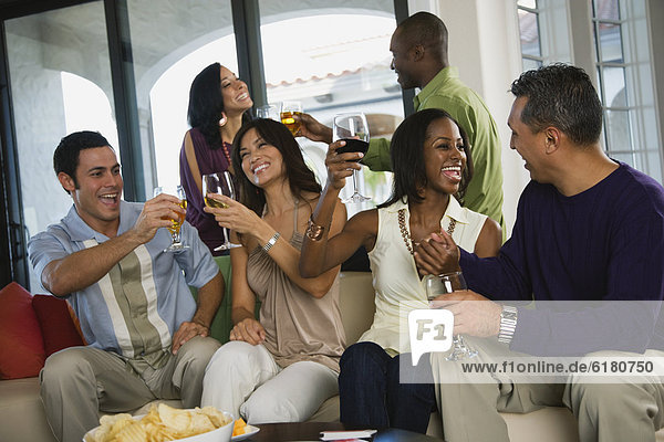 Multi-ethnic friends toasting at party