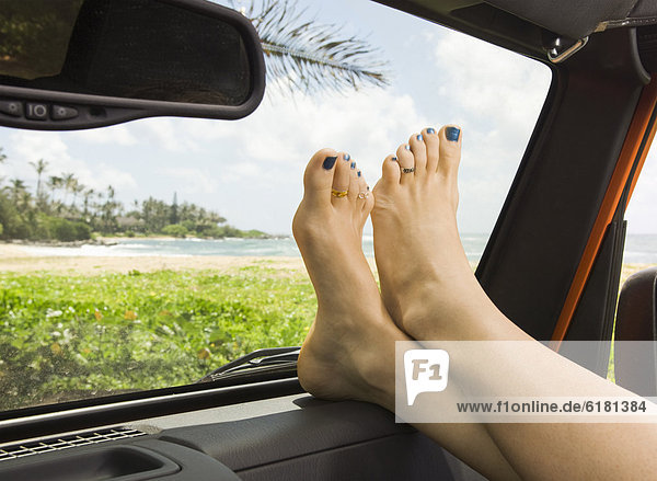 Woman with feet up in car