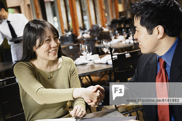 Asian businesspeople shaking hands