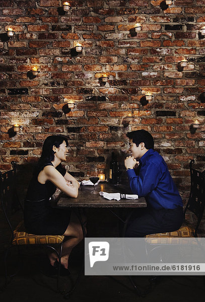 Asian couple eating at restaurant