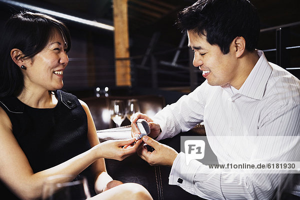 Asian man proposing to girlfriend