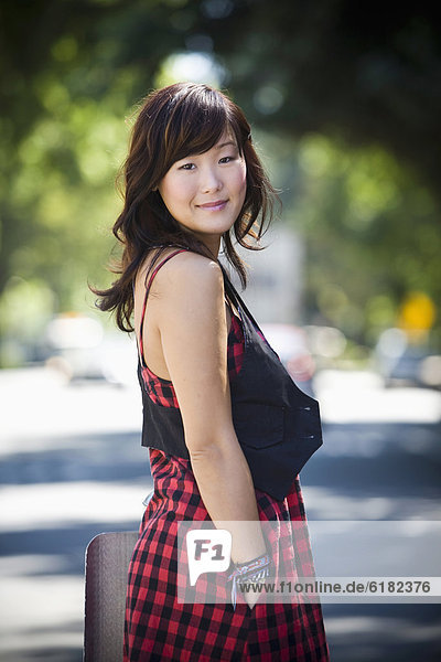 Smiling Korean woman standing outdoors