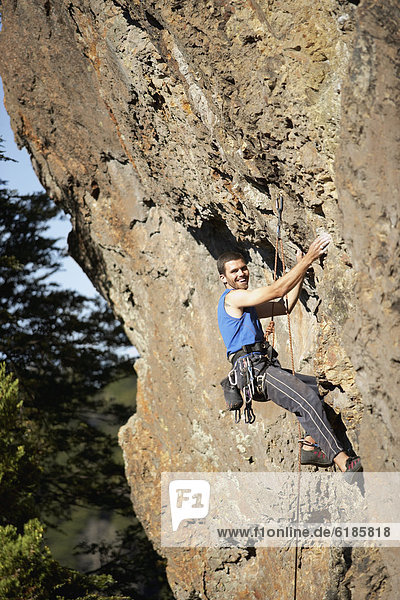 Argentinean man rock climbing