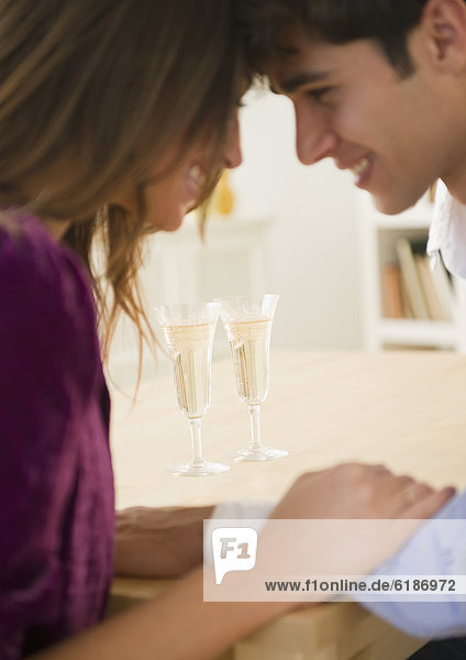 Couple holding hands and drinking Champagne