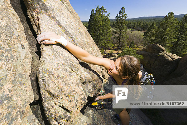 Caucasian woman rock climbing