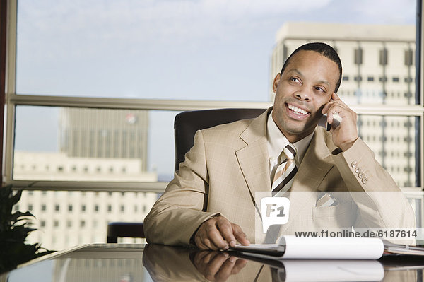 African businessman talking on cell phone