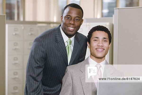 Multi-ethnic businessmen posing in office