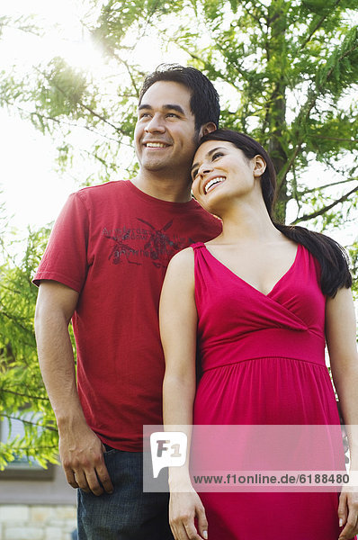 Hispanic couple standing together outdoors