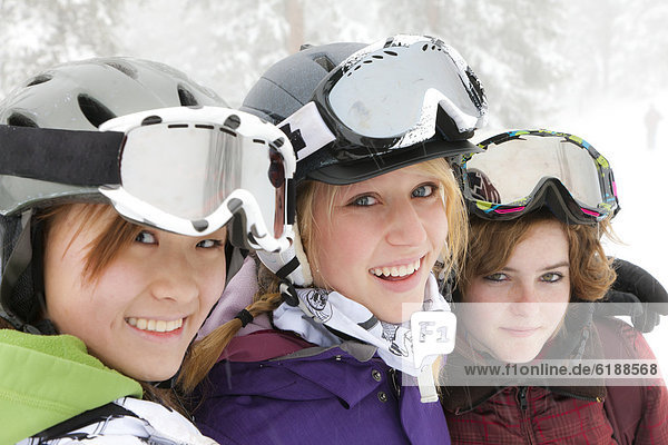 Smiling skiers hugging