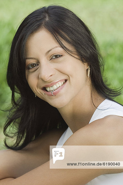 Smiling Hispanic woman with lip ring mouth