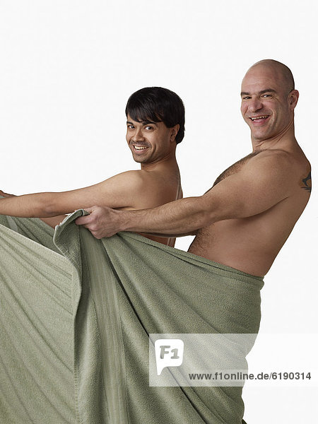 Nude men holding towel open