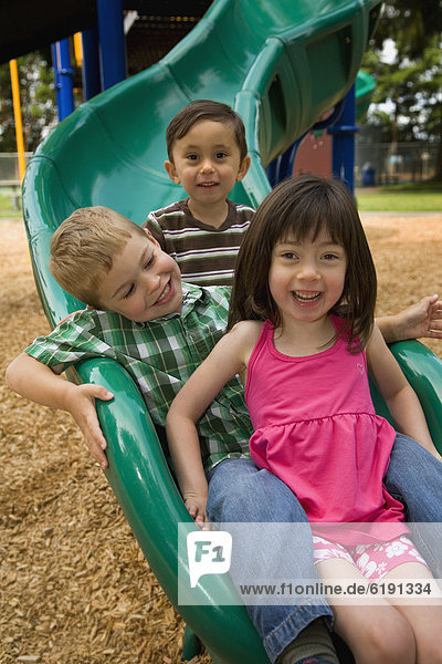 Children sliding in playground