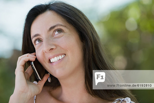 Hispanic woman talking on cell phone