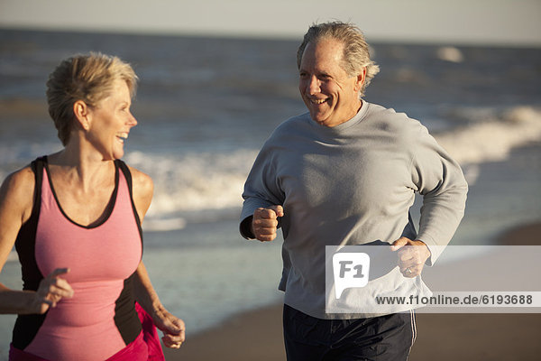 Couple running together on beach