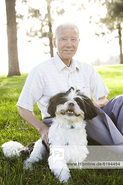 sitzend  Senior  Senioren  Mann  Hund  chinesisch  Gras