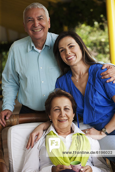 Smiling Hispanic parents and daughter