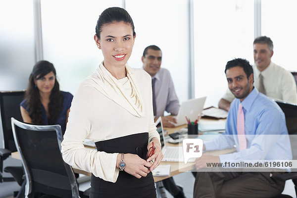 Hispanic business people working together in conference room