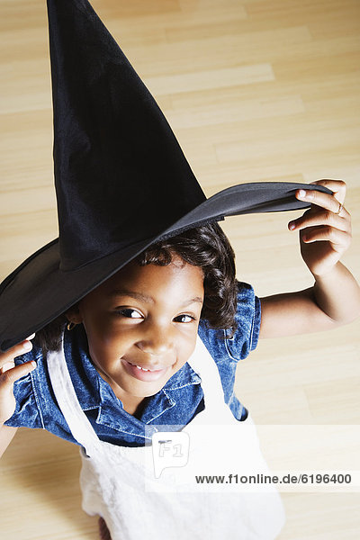 African girl wearing witch hat