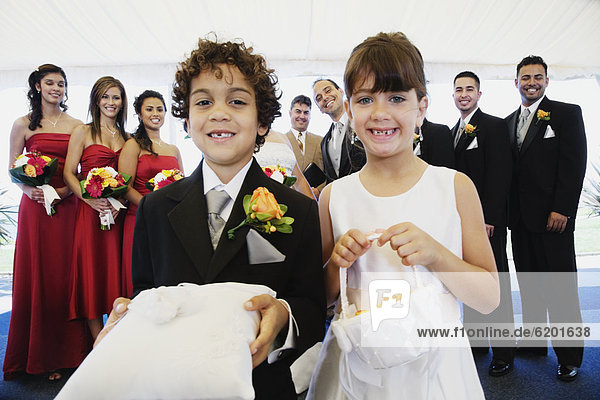 Hispanic boy and girl as ring bearer and flower girl