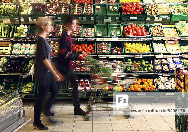Fruit and vegetable section  couple buying vegetables  food hall  supermarket  Germany  Europe