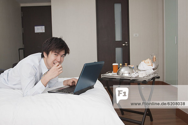 Asian businessman working in hotel room
