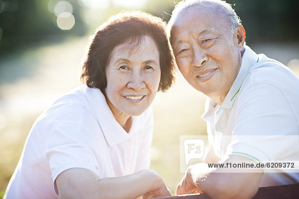 Smiling senior Chinese couple outdoors
