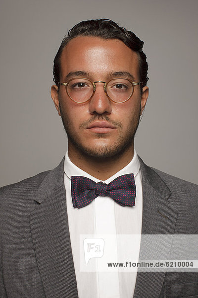 Serious Caucasian man in suit and bow tie