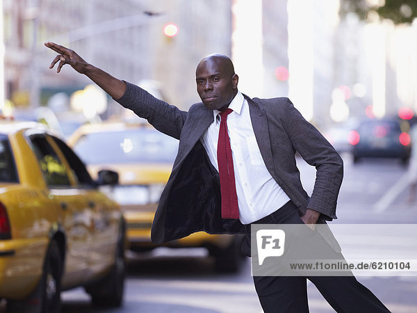 African businessman hailing taxi