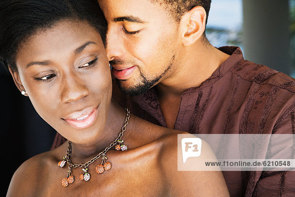 African couple hugging