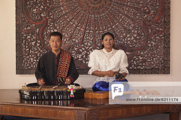 Asian man and woman with traditional musical instruments