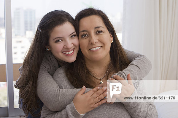 Chilean daughter hugging mother