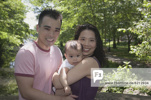 Chinese couple and baby in park