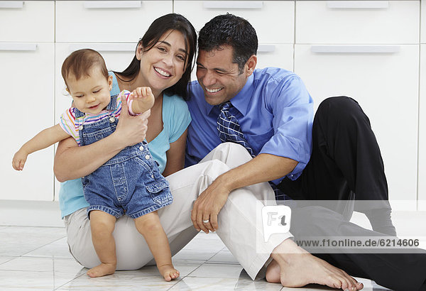Hispanic family sitting on floor