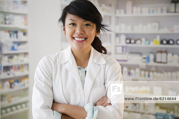 Pacific Islander pharmacist standing in pharmacy