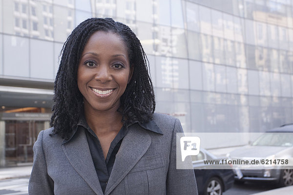 African businesswoman standing on urban street