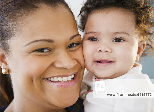 Smiling mixed race mother and baby
