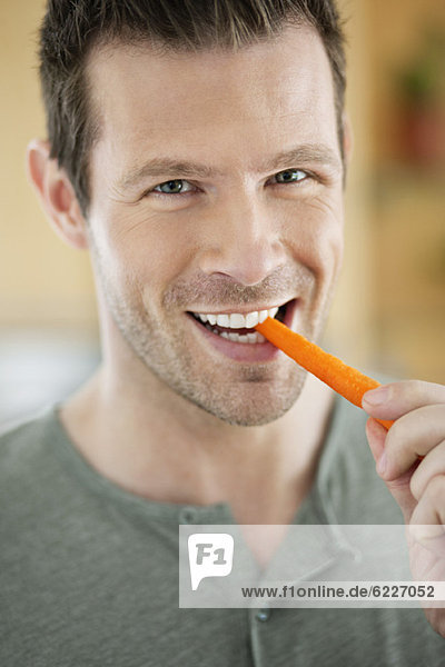 Man eating a carrot