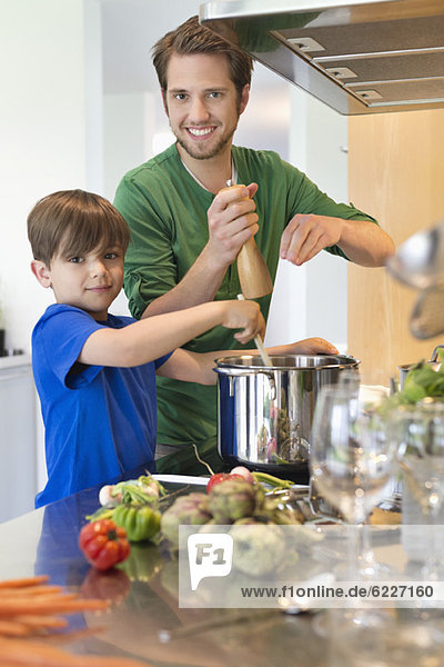 Boy assisting his father in the kitchen