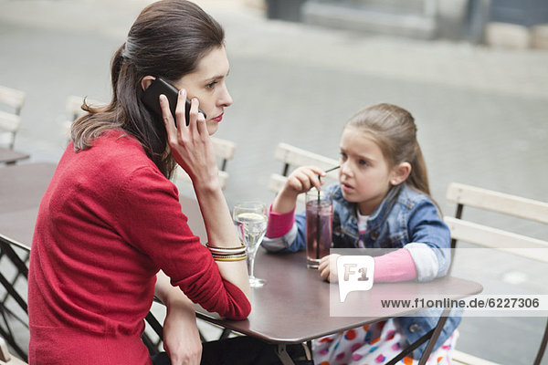 Woman with her daughter sitting in a cafe
