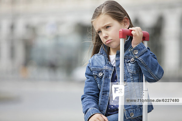 Close-up of a girl with her luggage