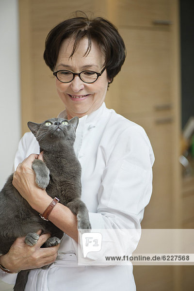 Woman holding a cat and smiling