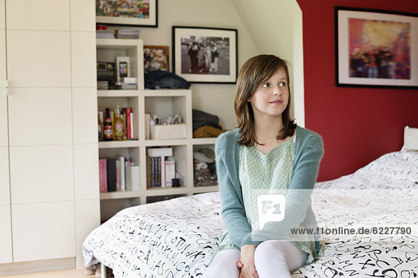 Girl sitting on the bed at home